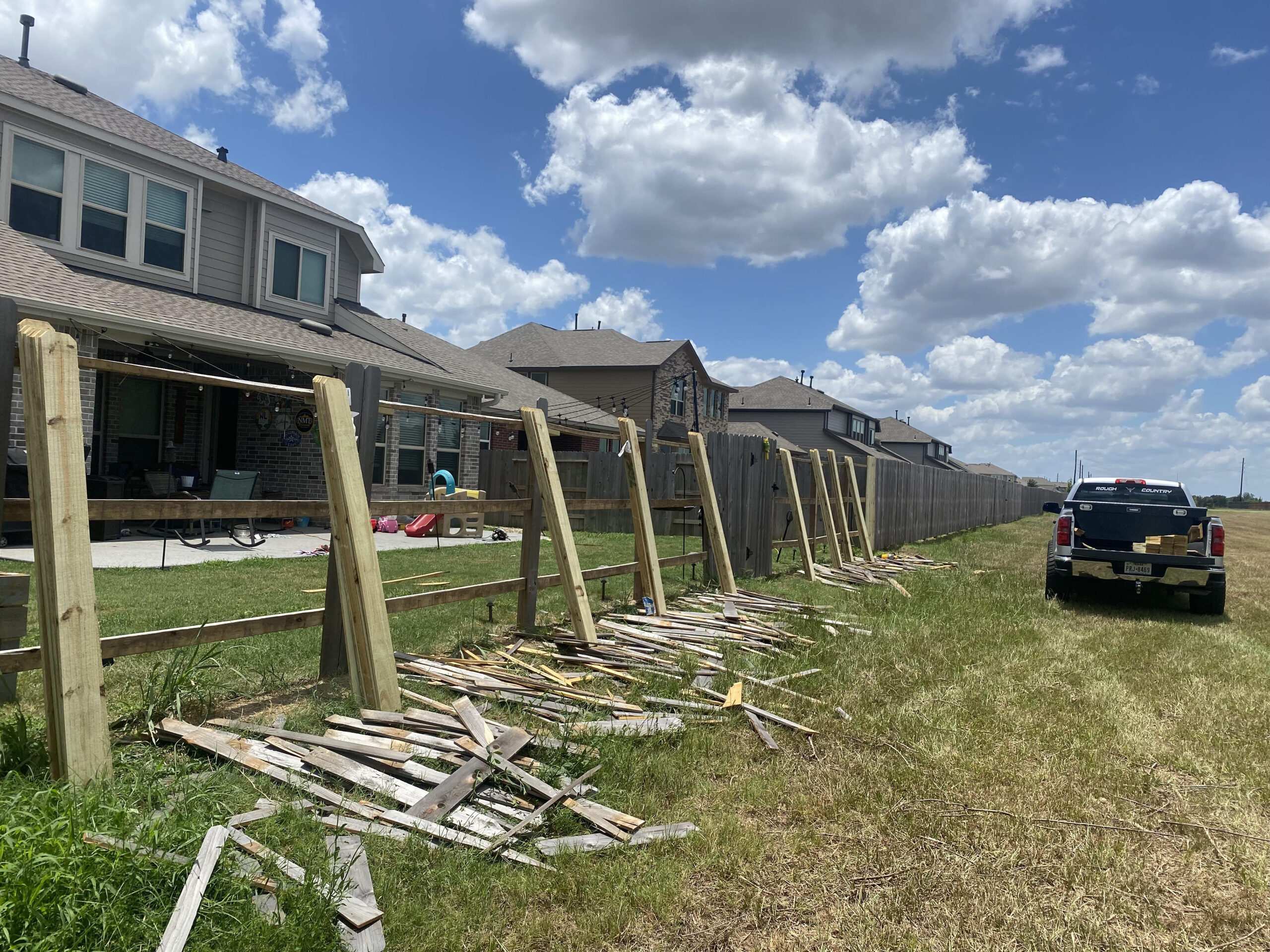 Wood fence under construction beside a home